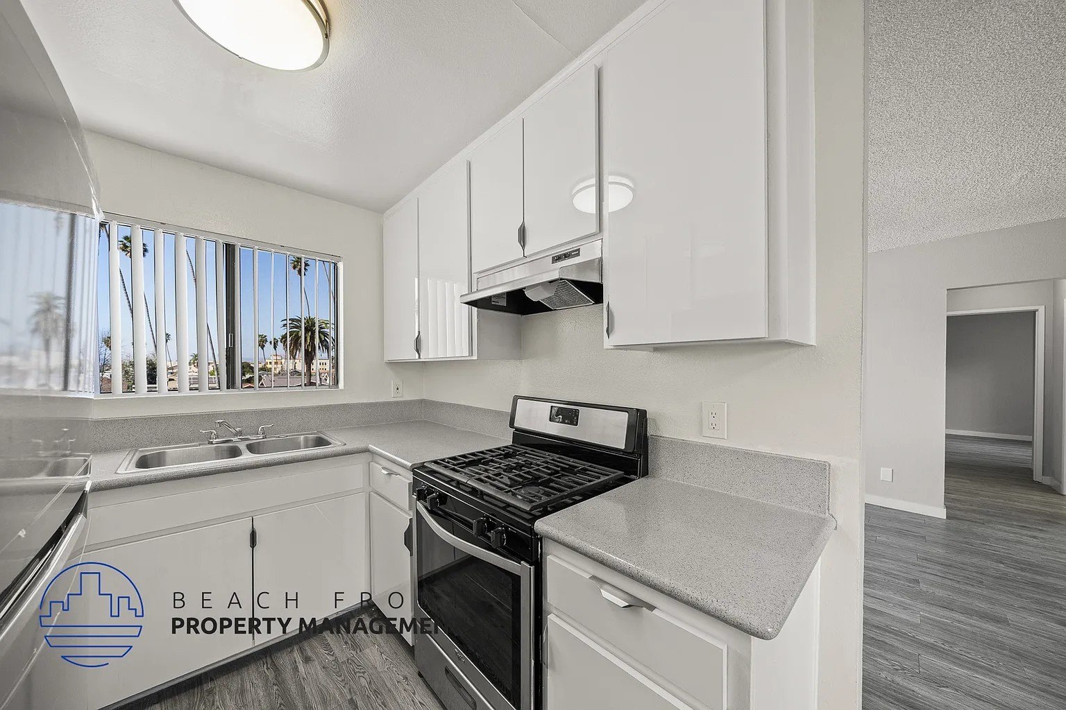 A kitchen with a stove top oven and a sink.